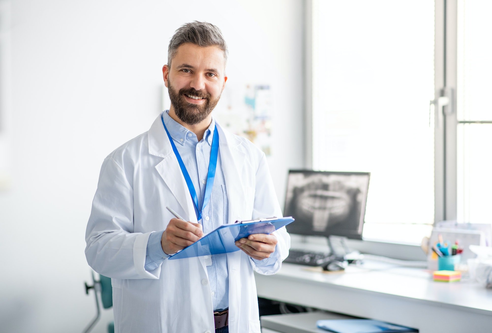 mature-dentist-in-modern-dental-surgery-looking-at-camera.jpg